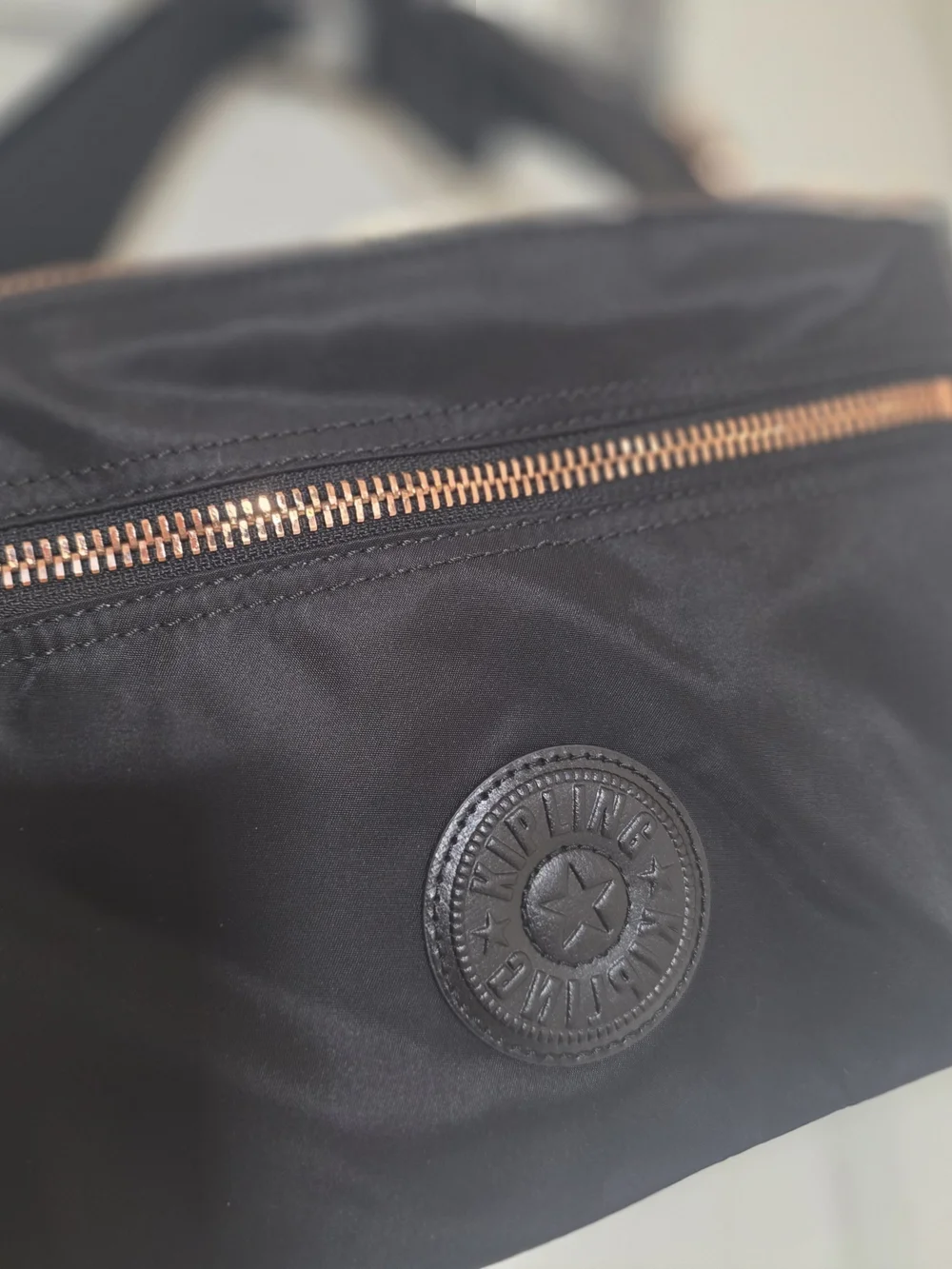 Kipling Black Crossbody with Rose Gold Hardware and Tan Tassel